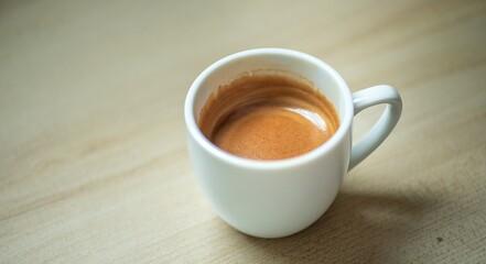 Espresso Tools: Professional Portafilter and Glass Cup with Rich Crema on Rustic Wooden Table...