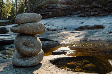Zen Cairn of Smooth Stones on a Creek Bank in the Sierra Nevada Wilderness