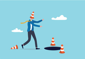 Blind and frustrated business direction, mistake or failure, trap or crisis ahead, risk and uncertainty concept, blindfold businessman cover with pylon walking to fall into the hole or business trap