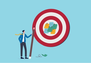 Goal setting, achievable target or purposeful objective, mission to accomplish or challenge to win for business success concept, businessman write down goal on notes and put on big dartboard target.