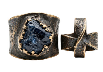 Extreme close-up macro shot of two weathered, oxidized bronze rings, one with a raw dark sapphire, on a transparent background with shallow depth of field, concept of ancient artifacts and forgotten