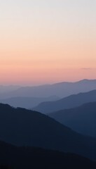Fototapeta premium Serene Sunset Over Mountain Ranges with Soft Color Gradients