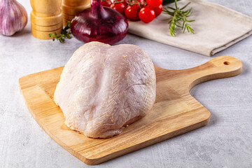 Raw chicken breast with bone and skin