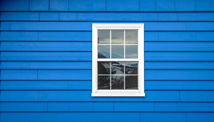Fototapeta premium Blue siding window white trim creates a striking contrast with minimalist design, featuring horizontal lines and a classic rectangular window centered in frame.