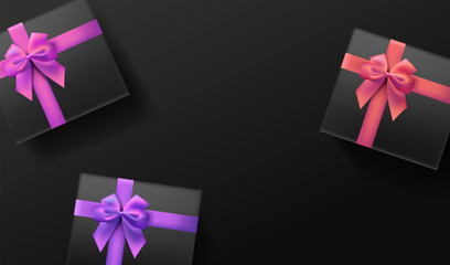 Black gift boxes with color bows on dark background