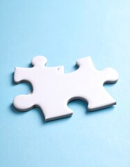 Obraz premium Single white jigsaw piece on a light blue background, slightly angled