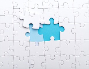 Obraz premium White jigsaw puzzle with two missing pieces revealing a light blue background