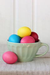 Colorful easter eggs in a ceramic cup celebrating spring holiday