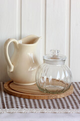 Ceramic pitcher and glass jar still life kitchenware, cottage kitchen background