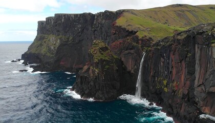 Dramatic coastal cliffs with waterfall