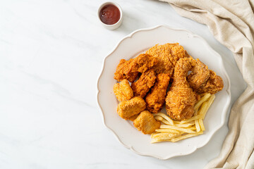 fried chicken with french fries and nuggets on plate
