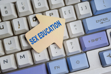 Concept of sex education write on sticky notes isolated on computer keyboard.