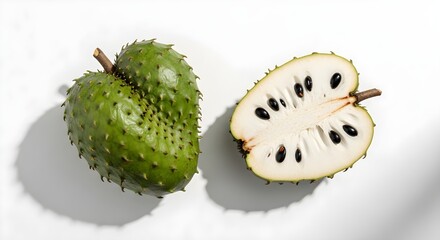 Whole and halved soursop (graviola) fruits with spiky green skin and creamy white flesh, beautifully displayed on a white background, highlighting their tropical flavor and health benefits.


