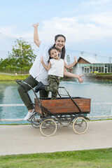 Asia and the Asian daughter are posing to take a hole in the lake.
