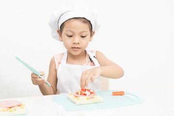 Girl are doing cooking activities on the white background.
