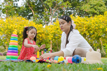 Girl and Mom Playing in the flower garden.