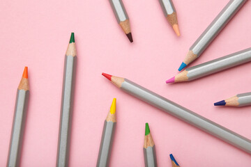 Many colorful pencils on pink background. Space for text