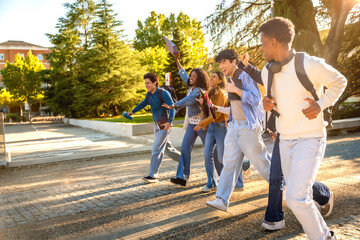 Fototapeta premium Diverse students running happy on university campus