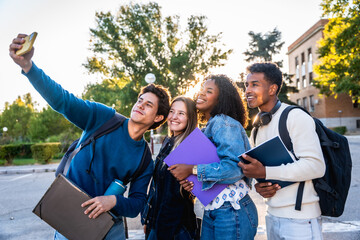 Diverse university students taking happy selfie on campus