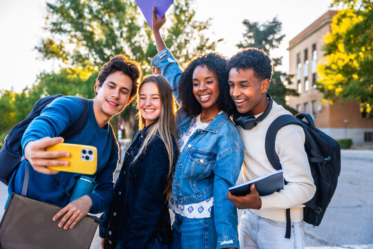 Diverse students taking selfie on university campus