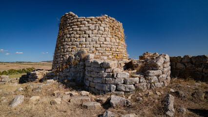 Nuraghe Piscu megalithic stone tower ruins in Suelli, Sardinia, under clear blue sky