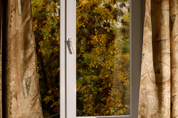 Obraz premium space inside view from window cozy room place with curtains and outside fall season time foliage background picture