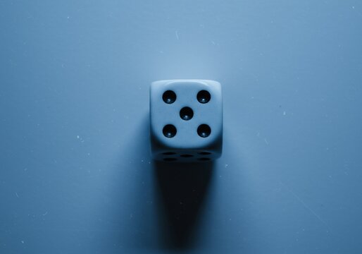 Top-Down Single Dice Blue Hour Product Photo with Film Grain