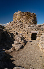 Nuraghe Piscu megalithic stone tower ruins in Suelli, Sardinia, under clear blue sky