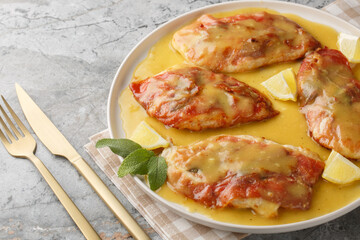 one pan chicken saltimbocca features prosciutto-draped chicken, crisp sage, and a lemony white wine sauce closeup on the plate on the table. Horizontal