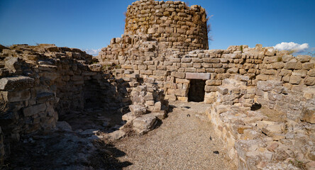 Nuraghe Piscu megalithic stone tower ruins in Suelli, Sardinia, under clear blue sky