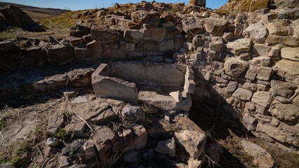 Nuraghe Piscu megalithic stone tower ruins in Suelli, Sardinia, under clear blue sky