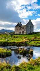 Fototapeta premium Ruined stone house by a stream in a grassy landscape