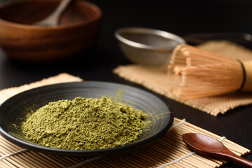 Matcha green tea powder traditional japanese healthy drink on black background