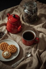 Red enamel coffee service with heart waffles cream and coffee beans storage jar