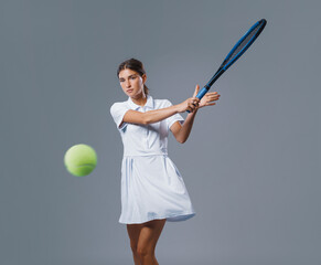 Young Female Tennis Player Hitting a Forehand on Neutral Background**