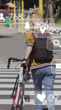 An albino african american man with dreadlocks crossing a street on his bicycle