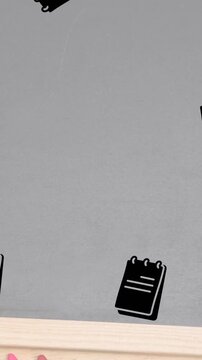 Multiple calendar icons falling against wooden slate and crayons on wooden table