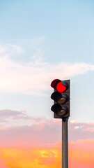 Red traffic light at sunset