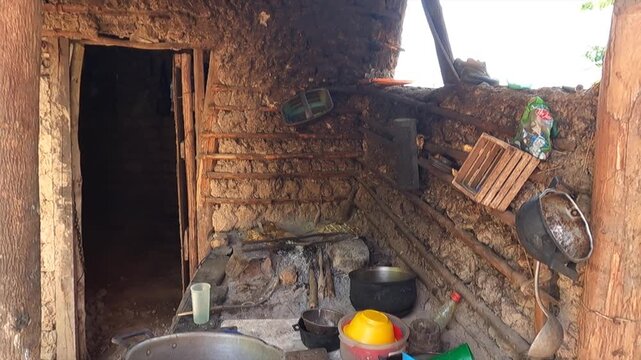 Simple outdoor kitchen in Caripito with wood cooking and pots