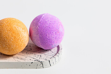 Brightly colored bath bombs displayed on a stylish tray in a bright setting