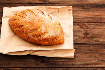 Freshly baked artisan bread on rustic wooden surface in cozy kitchen setting