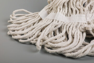 Mop with plastic handle isolated on gray	
