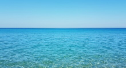 Fototapeta premium Serene ocean view with clear turquoise water under a bright blue sky