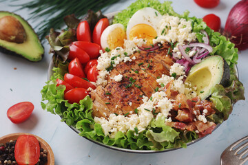 A bowl with cobb salad, traditional American dish	