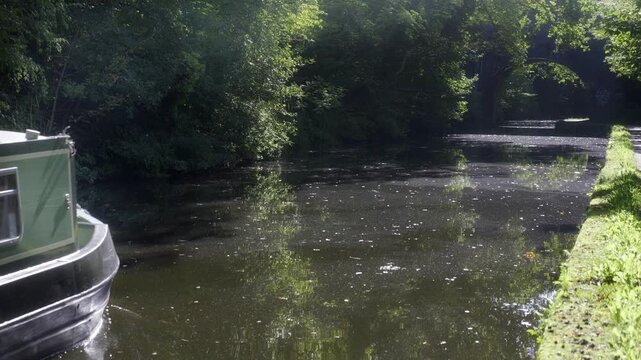 Narrowboat Cruising Along the Birmingham to Worcester Canal.
A traditional green narrowboat glides peacefully along the Birmingham to Worcester Canal.