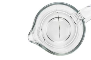 Top view of a black hair contaminating a glass measuring cup on a transparent background