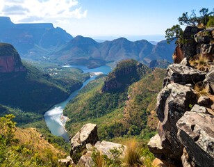 Panoramic vista of a valley carved by a river, surrounded by mountains