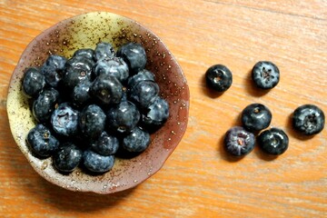 Fresh Blueberries in Rustic Ceramic Bowl on Wooden Table – Organic Superfood Photography