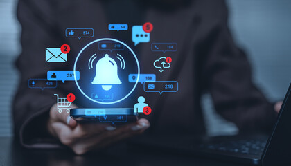 Digital notification icons floating above smartphone in hand representing online alerts and communication concept in modern digital workspace setting.