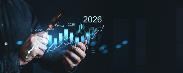 Hands analyzing financial data with magnifying glass showing upward trend from 2022 to 2026 on glowing chart in futuristic business concept.